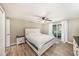 Bright main bedroom offers wood-look tile, ceiling fan, and sliding doors to the outdoor lanai at 15525 Old Dixie Hwy, Hudson, FL 34667