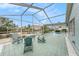 Relaxing screened patio with lovely chairs, a pristine pool, and tranquil canal views for the perfect outdoor living experience at 15525 Old Dixie Hwy, Hudson, FL 34667