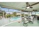 Inviting screened-in pool area with ample seating, a grill, and a view of the canal at 15525 Old Dixie Hwy, Hudson, FL 34667