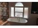 Bright bathroom featuring a freestanding tub and decorative tile accent wall at 1601 14Th N St, St Petersburg, FL 33704