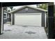 Detached two-car garage with white door and modern gray siding at 1601 14Th N St, St Petersburg, FL 33704
