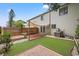 Well-maintained backyard with artificial turf, patio areas, and shade, offering a serene outdoor space at 1724 Adams S Cir, Largo, FL 33771