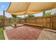 Cozy backyard featuring a canvas awning, brick patio and wooden deck, great for outdoor living at 1724 Adams S Cir, Largo, FL 33771