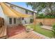 Landscaped backyard with a canvas awning and a combination of wood, brick and gravel elements at 1724 Adams S Cir, Largo, FL 33771