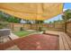 Inviting backyard with paver patio, wooden deck, and shade features for outdoor enjoyment at 1724 Adams S Cir, Largo, FL 33771