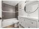 Updated bathroom with a stylish vanity, modern fixtures, and tiled shower-tub combo at 1724 Adams S Cir, Largo, FL 33771