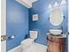 Stylish powder room featuring a unique vanity with vessel sink and modern fixtures at 1724 Adams S Cir, Largo, FL 33771