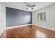 Spacious bedroom with hardwood floors, ample natural light, and a ceiling fan at 1724 Adams S Cir, Largo, FL 33771