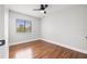 Cozy bedroom featuring hardwood floors, a ceiling fan, and a bright window at 1724 Adams S Cir, Largo, FL 33771