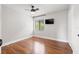 Bedroom features hardwood floors, ceiling fan, and window allowing ample natural light at 1724 Adams S Cir, Largo, FL 33771