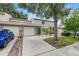 Charming townhome featuring a two-car garage, well-maintained landscaping, and a welcoming entrance at 1724 Adams S Cir, Largo, FL 33771