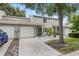 Charming townhome featuring a two-car garage, well-maintained landscaping, and a welcoming entrance at 1724 Adams S Cir, Largo, FL 33771