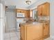 Functional kitchen featuring granite counters, an island, and essential white appliances at 1724 Adams S Cir, Largo, FL 33771