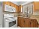 Bright kitchen features modern appliances, granite countertops, and wood cabinetry at 1724 Adams S Cir, Largo, FL 33771