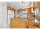 Compact kitchen featuring granite countertops, white appliances, and ample cabinetry at 1724 Adams S Cir, Largo, FL 33771