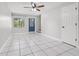 Bright living room with tiled floors, a ceiling fan, and a blue painted entry door at 1724 Adams S Cir, Largo, FL 33771