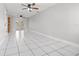 Spacious living room featuring tiled floors, ceiling fans and patio doors for lots of natural light at 1724 Adams S Cir, Largo, FL 33771