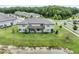 Aerial view of the townhome showcases the backyard, pond, and neighborhood at 17482 Nectar Flume Dr, Land O Lakes, FL 34638