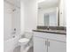 Bathroom featuring vanity with sink, granite counter, and a shower-tub combo at 17482 Nectar Flume Dr, Land O Lakes, FL 34638