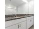 Modern bathroom with double sink vanity, granite countertop and white cabinets at 17482 Nectar Flume Dr, Land O Lakes, FL 34638