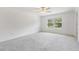 Large bedroom with natural light, soft carpeting and a ceiling fan at 17482 Nectar Flume Dr, Land O Lakes, FL 34638