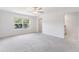 Spacious bedroom featuring plush carpet and a large window with scenic outdoor views at 17482 Nectar Flume Dr, Land O Lakes, FL 34638