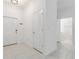 Bright entryway features white walls, neutral tile floors, and access to a powder room at 17482 Nectar Flume Dr, Land O Lakes, FL 34638