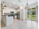 Modern kitchen features stainless steel appliances and a view of the tranquil pond at 17482 Nectar Flume Dr, Land O Lakes, FL 34638