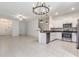 Open-concept living space with white kitchen cabinets and stainless steel appliances at 17482 Nectar Flume Dr, Land O Lakes, FL 34638