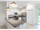 Bright and airy kitchen with stainless steel appliances, granite countertops, and white cabinetry at 17482 Nectar Flume Dr, Land O Lakes, FL 34638