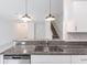 Kitchen with granite countertops overlooks the spacious living area and staircase at 17482 Nectar Flume Dr, Land O Lakes, FL 34638