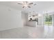 Open-concept living room and kitchen area with tile floors and access to the outdoors at 17482 Nectar Flume Dr, Land O Lakes, FL 34638