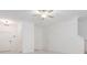 Bright, white living room with modern ceiling fan and tile flooring at 17482 Nectar Flume Dr, Land O Lakes, FL 34638