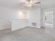 Loft area with carpeting and staircase, perfect for relaxation or recreation at 17482 Nectar Flume Dr, Land O Lakes, FL 34638