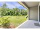 Covered patio with picturesque views of the green landscape and mature trees at 17482 Nectar Flume Dr, Land O Lakes, FL 34638