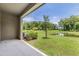 Relaxing covered patio with a view of a serene pond and lush green space at 17482 Nectar Flume Dr, Land O Lakes, FL 34638