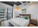 Modern bedroom with dark wood accents and large window overlooking the city at 175 2Nd St S # P-2, St Petersburg, FL 33701