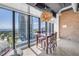 Bright dining area with city views, industrial-style ceiling, and modern chandelier at 175 2Nd St S # P-2, St Petersburg, FL 33701