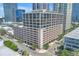 An eye-level outdoor shot captures a multi-story condominium building that rises above a brick parking structure below at 175 2Nd St S # P-2, St Petersburg, FL 33701
