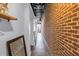 Hallway featuring exposed brick wall, mirrors and view of outside at 175 2Nd St S # P-2, St Petersburg, FL 33701