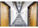 Long hallway with neutral walls and gray carpet leading to apartment units at 175 2Nd St S # P-2, St Petersburg, FL 33701