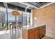 Kitchen features exposed brick, island and windows showcasing panoramic city views at 175 2Nd St S # P-2, St Petersburg, FL 33701