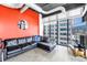 Modern living room boasts an exposed ceiling, floor-to-ceiling windows, and a comfortable black leather sectional sofa at 175 2Nd St S # P-2, St Petersburg, FL 33701