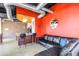 Open-concept living area featuring a brick accent wall, an adjacent bar area, and a comfortable leather sectional sofa at 175 2Nd St S # P-2, St Petersburg, FL 33701