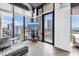 Bright living space with floor-to-ceiling windows showcasing a stunning cityscape and access to a private balcony at 175 2Nd St S # P-2, St Petersburg, FL 33701