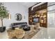Stylish living room boasts modern furnishings, a sleek entertainment center, and a chic circular mirror at 175 2Nd St S # P-2, St Petersburg, FL 33701