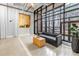 Building lobby with stylish gray sofa and brick accent wall and large window at 175 2Nd St S # P-2, St Petersburg, FL 33701