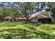 Expansive backyard featuring lush lawn and mature trees, ideal for outdoor living at 1835 Alicia Way, Clearwater, FL 33764