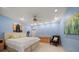 Large bedroom offering a queen-size bed, ceiling fan, and an entertainment center at 1835 Alicia Way, Clearwater, FL 33764