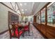 Elegant dining room with a long wood table, chairs, and built-in display cabinets and storage at 1835 Alicia Way, Clearwater, FL 33764